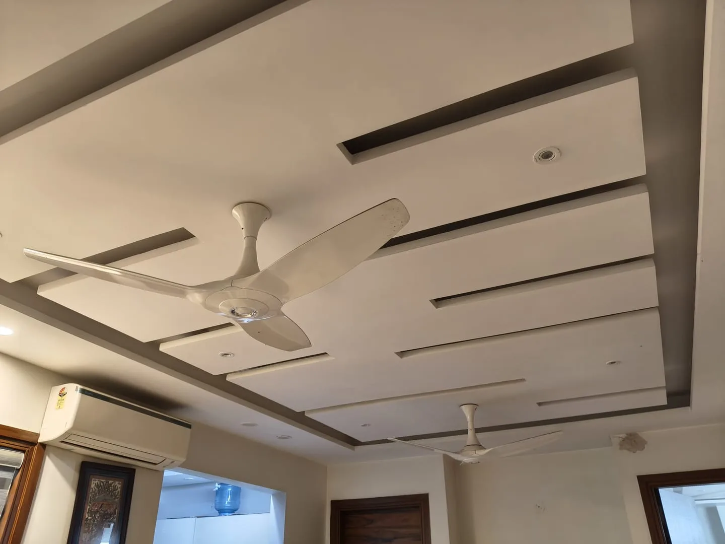 Warm false ceiling lighting detail in a living room